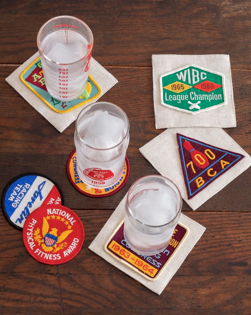 DIY vintage fabric patches used as drink coasters on old wood coffee table.