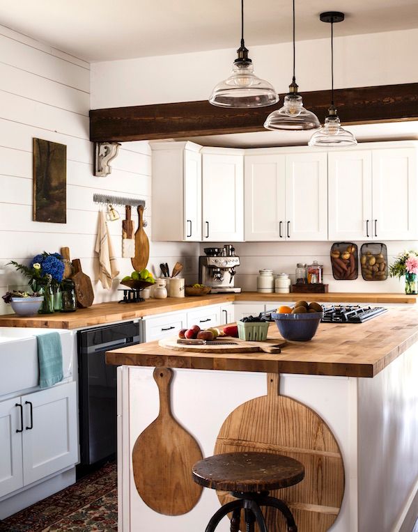 Vintage breadboards hanging in a kitchen as decor.