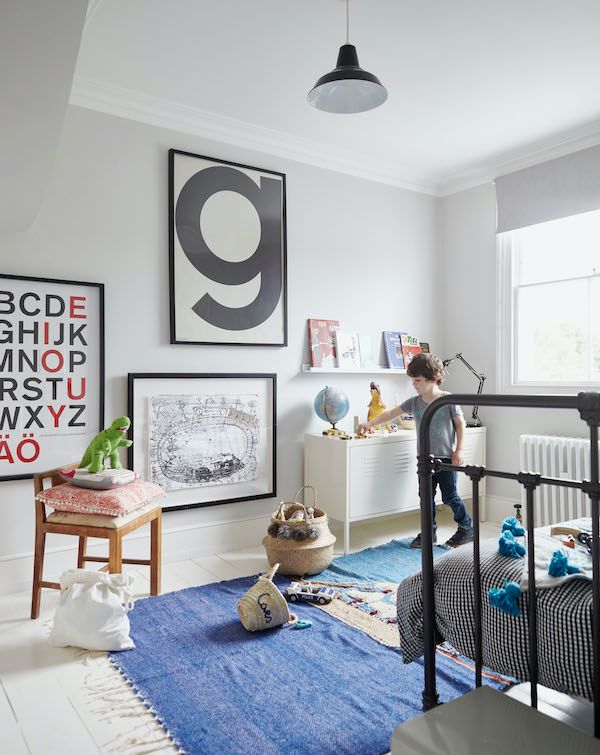 Kid's room with white walls and graphic typography artwork.