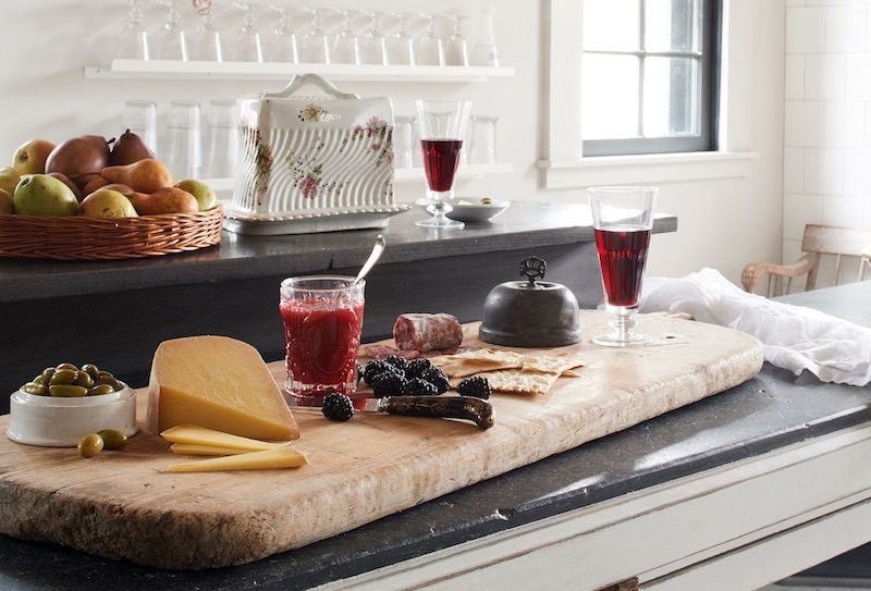 Vintage breadboard used as a charcuterie tray.