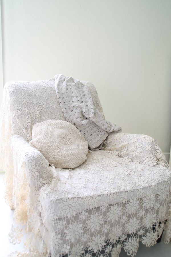 Vintage lace and crochet tablecloth covering a vintage side chair.
