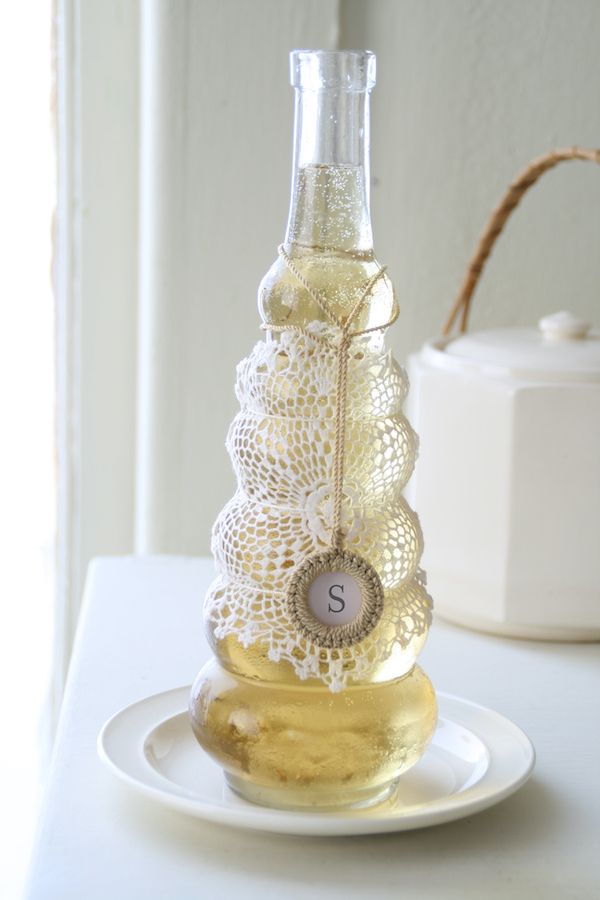 DIY crochet wrapped around a glass wine decanter.