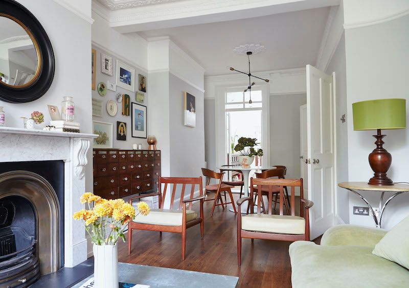 Open living and dining room space with a mix of vintage and modern furniture and accessories.