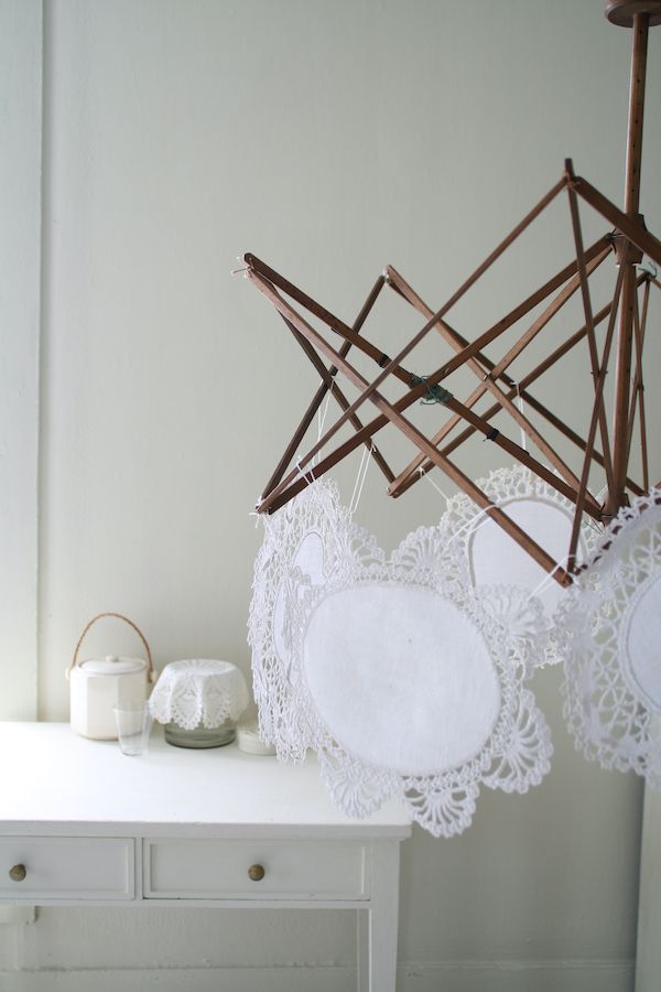 A vintage drying rack with circular doilies.