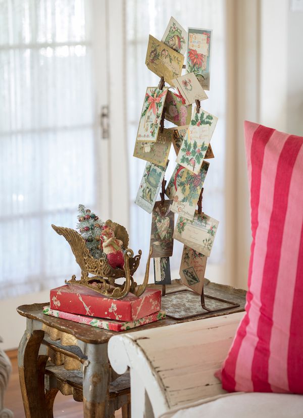A metal store fixture stand turned into a display for a collection of Christmas cards.