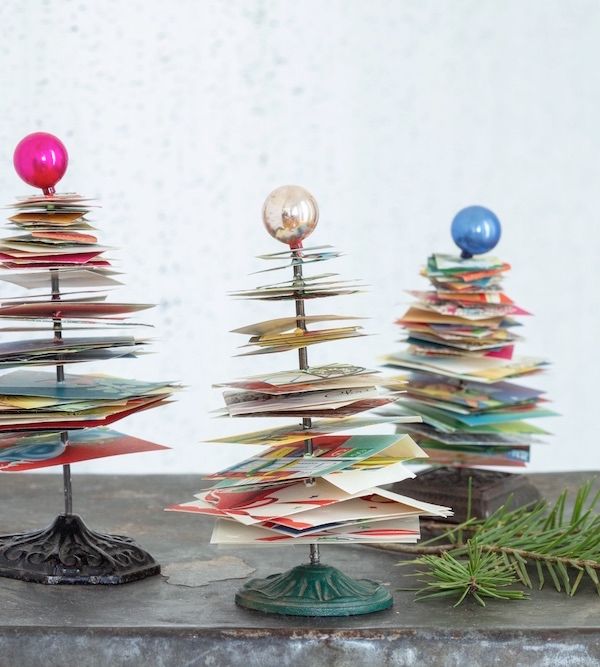 Vintage receipt spikes repurposed as holiday trees using old greeting cards.