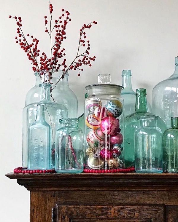 Old glass jars filled with vintage ornaments.