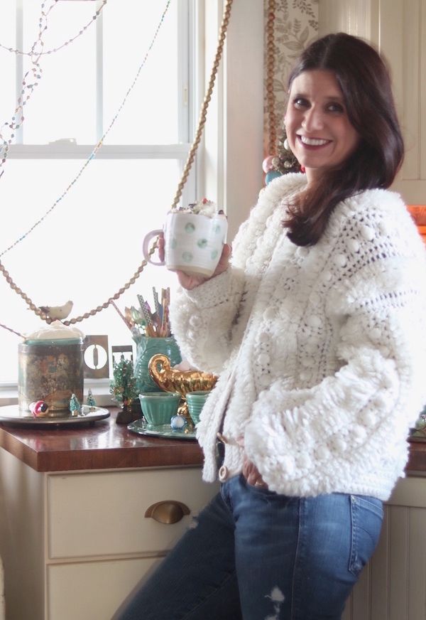 Melissa Parks enjoying hot chocolate in a vintage mug.