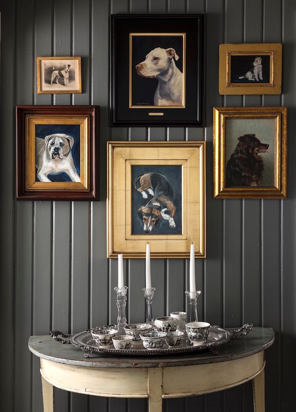 Gallery wall with vintage dog paintings.
