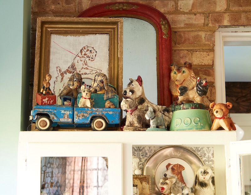 Chalkware and dogs on display in vintage blue truck.