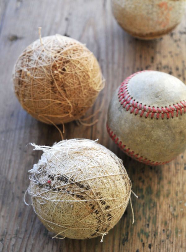 Old baseballs, some are stripped of their leather.