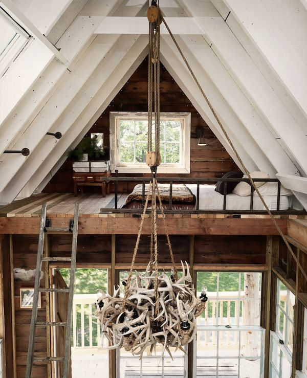 Antler chandelier hanging in rustic cabin.