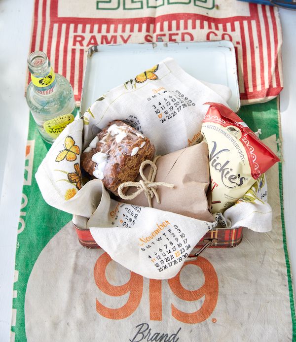 Vintage tin lunchboxes used to serve lunch at an outdoor potting party.