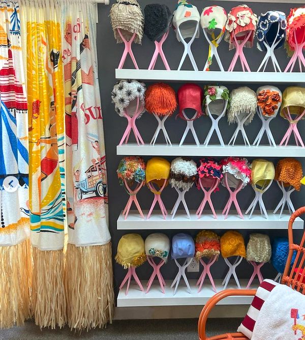 Vintage swim cap collection on display.