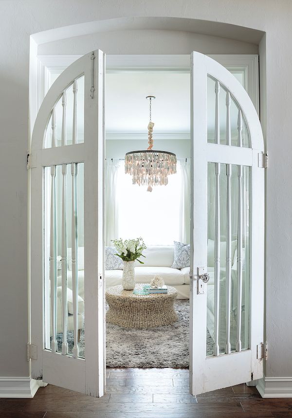 Rounded white vintage glass doors act as a room separator.