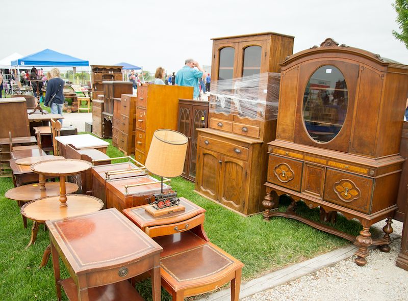 Vintage furniture on lawn at flea market.