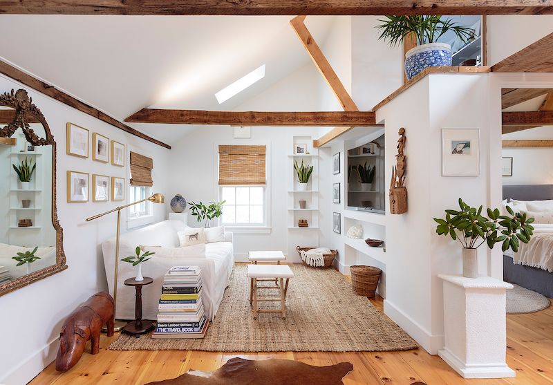 Living room with white walls and rustic wood exposed beams.