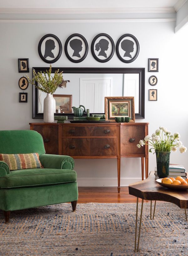 Silhouettes hanging above a mirror in living room.