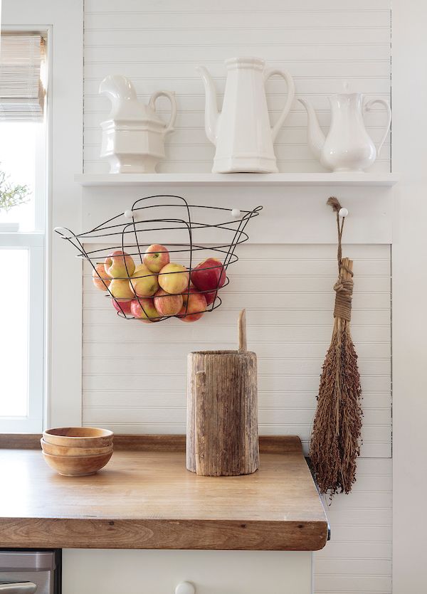 White bead board in kitchen with wood countertops.