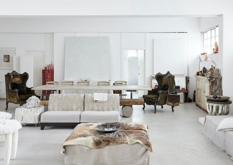 Bright living area with long dining table and vintage decor.