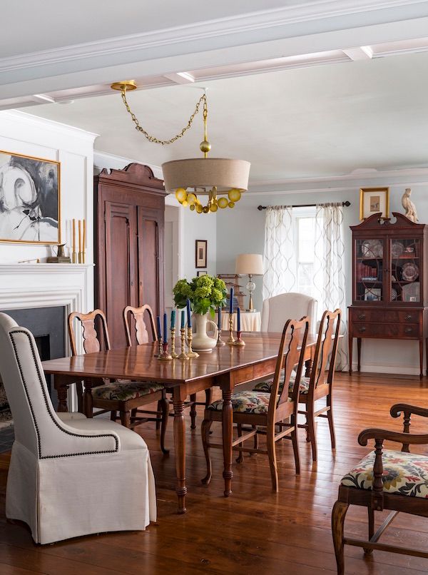 Dining room with antique furniture and retro light fixture.