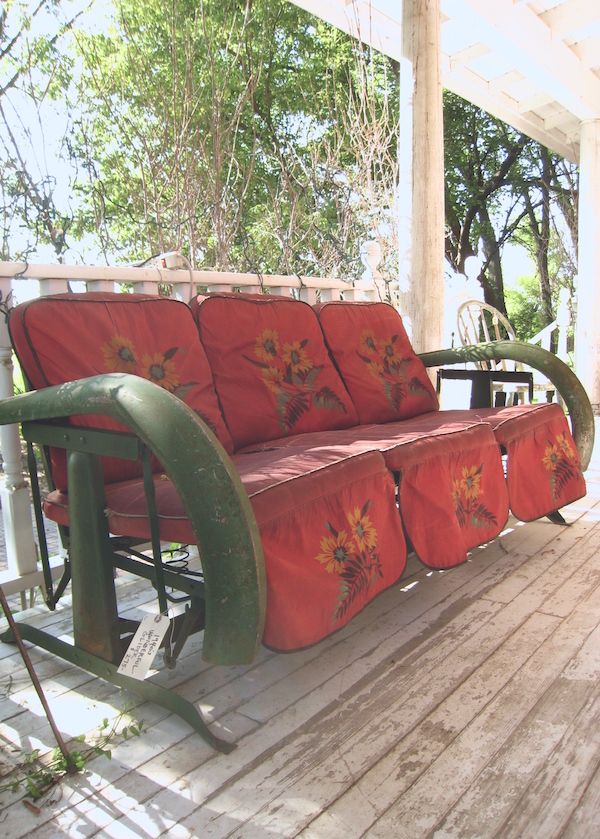 Vintage red and green glider on front porch.