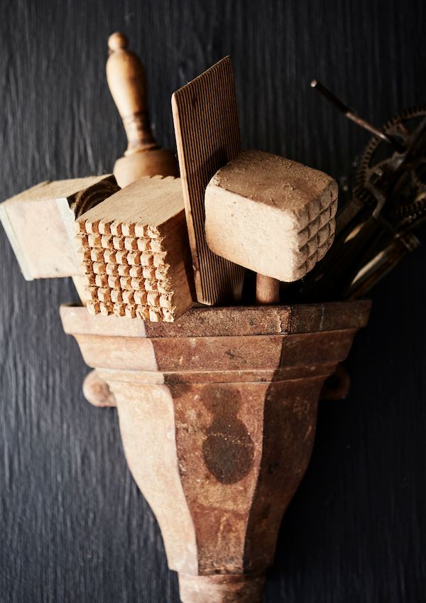 A piece of Victorian molding used to hold kitchen implements.