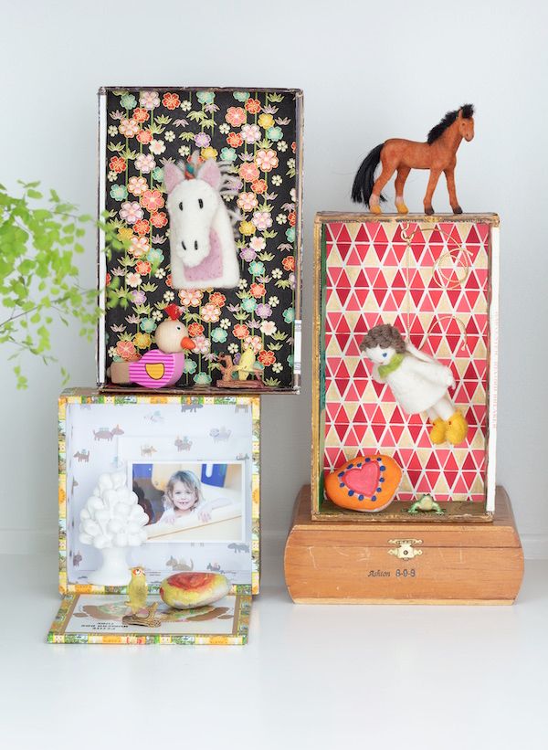Vintage cigar boxes used to display children's items.