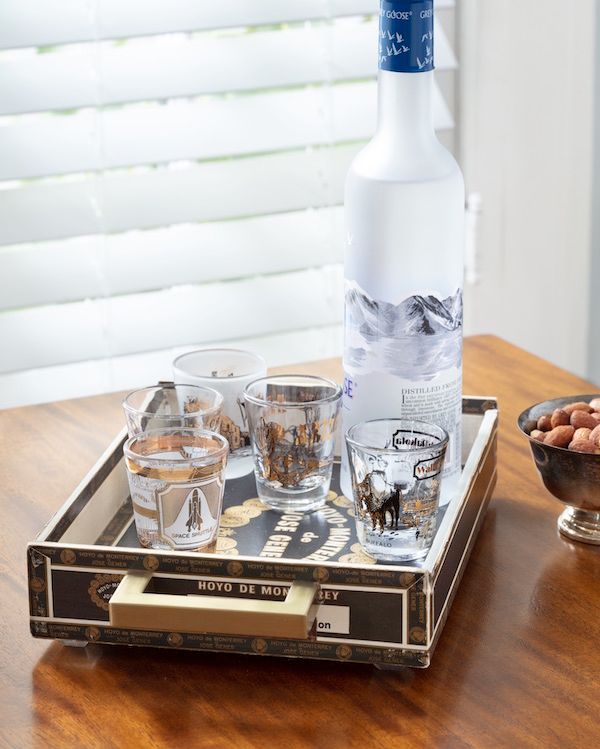Vintage cigar box used as a drink tray.